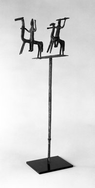 Bamana. <em>Staff with Equestrian Figures</em>, late 19th-early 20th century. Wrought iron, 19 1/2 x 8 x 1 3/4 in. (without attached metal base). Brooklyn Museum, Gift of Elliot Picket, 70.72.5. Creative Commons-BY (Photo: Brooklyn Museum, 70.72.5_bw.jpg)