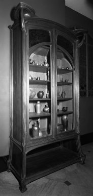 Jacques Gruber (French, 1870–1936). <em>Bookcase</em>, ca. 1904. Mahogany, rosewood, oak, glass and brass., 110 x 60 x 22 1/2 in. (279.4 x 152.4 x 57.2 cm). Brooklyn Museum, Restricted Income Fund, 71.77. Creative Commons-BY (Photo: Brooklyn Museum, 71.77_bw.jpg)