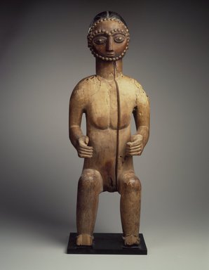 Possibly Wobe. <em>Seated Male Figure</em>, late 19th–early 20th century. Wood, metal studs, metal base, height (with base): 28 3/4 x 10 x 7 in. (73 x 25.4 x 17.8 cm). Brooklyn Museum, Gift of Fernandez Arman to the Jennie Simpson Educational Collection of African Art, 72.102.6. Creative Commons-BY (Photo: Brooklyn Museum, 72.102.6.jpg)