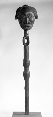 Luba. <em>Staff with Masquette Attached at the Top</em>, late 19th or early 20th century. Wood, 23 1/4 x 5 x 3 1/4 in. (59.0 x 13.0 x 8.3 cm). Brooklyn Museum, Gift of Marcia and John Friede, 73.107.3. Creative Commons-BY (Photo: Brooklyn Museum, 73.107.3_bw.jpg)
