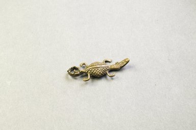 Asante. <em>Weight</em>. Cast brass, 3/4 x 2 in. (1.9 x 5.1 cm). Brooklyn Museum, The Franklin H. Williams Collection of Ashanti Brass Weights and Accessory Objects for Weighing Gold, Gift of Mr. and Mrs. Franklin H. Williams, 74.218.71. Creative Commons-BY (Photo: Brooklyn Museum, 74.218.71_front_PS5.jpg)