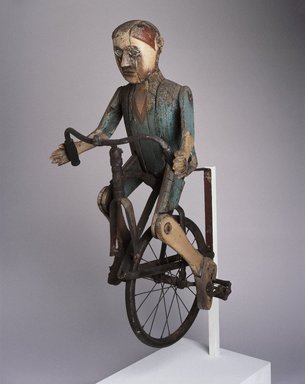 Lewis Simon (American, 1884-1970). <em>Trade Sign (Boy Riding Bicycle)</em>, 1932-1934. Painted wood, metal, rubber, other materials, 40 1/2 x 18 x 23 in.  (102.9 x 45.7 x 58.4 cm). Brooklyn Museum, H. Randolph Lever Fund and Dick S. Ramsay Fund, 74.29. Creative Commons-BY (Photo: Brooklyn Museum, 74.29_SL1.jpg)