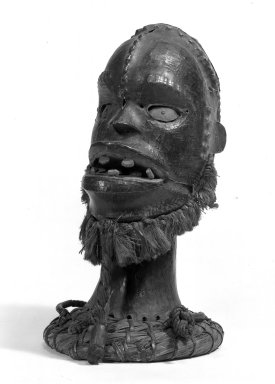 Ejagham. <em>Skin-covered Headdress with Raffia Beard</em>, late 19th or early 20th century. Wood, antelope skin, fiber, pigment, metal, 13 1/2 x 8 in. (34.3 x 20.3 cm). Brooklyn Museum, Gift of Mr. and Mrs. John A. Friede, 74.66.2. Creative Commons-BY (Photo: Brooklyn Museum, 74.66.2_bw.jpg)