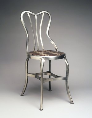 Clement Uhl (American, 1878–1964). <em>"Perfection" Chair, model 151</em>, 1903. Steel (possibly nickel plated), wood, plastic, Overall Height:  34 1/2 in.  (87.6 cm); . Brooklyn Museum, Gift of Mr. and Mrs. Jonathan Holstein, 75.108. Creative Commons-BY (Photo: Brooklyn Museum, 75.108_transp3721.jpg)