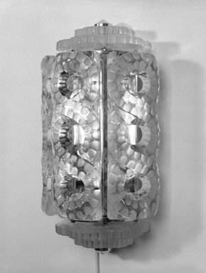 Rene J. Lalique (1860-1945). <em>One of a Pair of Sconce</em>, ca. 1930. Glass, chromium, 14 1/2 x 7 1/4 x 5 in. (36.8 x 18.4 x 12.7 cm). Brooklyn Museum, Gift of Mrs. MacDonald Mathey, 75.22.2a-h. Creative Commons-BY (Photo: Brooklyn Museum, 75.22.2a-h_bw.jpg)