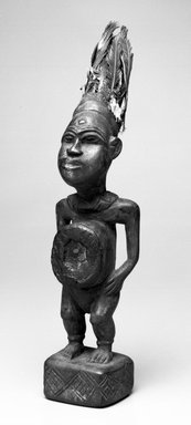 Kongo. <em>Standing Figure with Hands Resting on Hips</em>, 20th century. Wood, glass mirror, resin, feathers, 14 1/2 x 3 1/2 x 4 1/4 in. (36.8 x 9.0 x 11.5 cm). Brooklyn Museum, Gift of Robert A. Levinson, 75.76. Creative Commons-BY (Photo: Brooklyn Museum, 75.76_bw.jpg)