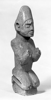 Kongo. <em>Male Figure Kneeling on a Pedestal (Ntadi)</em>, late 19th-early 20th century. Steatite, 12 3/4 x 3 1/2 x 4 in. (32.4 x 8.9 x 10.2 cm). Brooklyn Museum, Gift of Marcia and John Friede, 75.82.3. Creative Commons-BY (Photo: Brooklyn Museum, 75.82.3_bw.jpg)