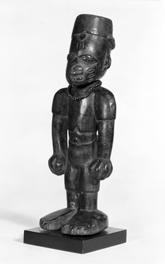 Yorùbá artist. <em>Male twin figure (Ère Ìbejì)</em>, late 19th or early 20th century. Wood, pigment, glass beads, h: 9 1/2 in. (24 cm). Brooklyn Museum, Gift of Mr. and Mrs. E. H. Polak, 75.86.2. Creative Commons-BY (Photo: Brooklyn Museum, 75.86.2_bw.jpg)