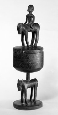 Dogon. <em>Hemispherical Pedestal Cup with Figures</em>, late 19th or early 20th century. Wood, h: 21 1/2 in. (54.5 cm). Brooklyn Museum, Gift of Mr. and Mrs. Milton F. Rosenthal, 77.246.3a-b. Creative Commons-BY (Photo: Brooklyn Museum, 77.246.3a-b_bw.jpg)