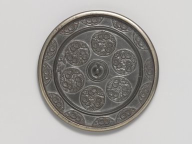  <em>Mirror</em>, 14th century. Cast bronze, 5/16 x 4 3/8 in. (0.8 x 11.1 cm). Brooklyn Museum, Designated Purchase Fund, 77.55.4. Creative Commons-BY (Photo: Brooklyn Museum, 77.55.4_PS4.jpg)