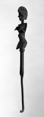 Yorùbá. <em>Ogun Staff with Kneeling Female Figure (Iwara Ogun)</em>, late 19th or early 20th century. Copper alloy, iron, 20 5/8 in. (52.5 cm). Brooklyn Museum, Gift of Dr. and Mrs. Abbott A. Lippman, 78.178.1. Creative Commons-BY (Photo: Brooklyn Museum, 78.178.1_bw.jpg)