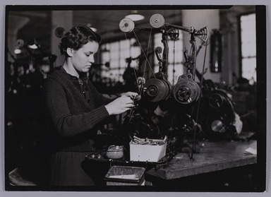 Lewis Wickes Hine (American, 1874-1940). <em>[Untitled]  (Young Woman Standing at Tabletop Thread Machine)</em>, 1936-1937. Gelatin silver print, 4 3/4 x 7 1/4 in.  (12.1 x 18.4 cm). Brooklyn Museum, Gift of the National Archives, 79.143.139 (Photo: Brooklyn Museum, 79.143.139_PS20.jpg)