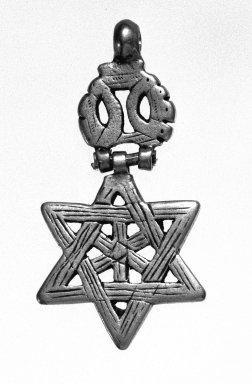 Amhara. <em>Pendant in form of Star of David</em>, 19th or 20th century. Silver, 2 1/8 x 1 1/8 in. (5.3 x 2.8 cm). Brooklyn Museum, Gift of George V. Corinaldi Jr., 79.72.7. Creative Commons-BY (Photo: Brooklyn Museum, 79.72.7_view1_bw.jpg)
