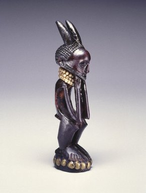 Nsapo-Nsapo. <em>Squatting Male Figure</em>, late 19th century. Wood, copper alloy, glass beads, fiber, organic materials, 7 1/2 x 1 3/4 x 2 in. (19.1 x 4.4 x 5.1 cm). Brooklyn Museum, Purchased with funds given by Frieda and Milton F. Rosenthal and Carll H. de Silver Fund, 80.100. Creative Commons-BY (Photo: Brooklyn Museum, 80.100_threequarter_SL1.jpg)