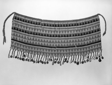  <em>Piece of African Costume</em>, late 19th to early 20th century. Cotton, beads, cowrie shells, metal, fiber, 21 x 10 1/2 in. (53.3 x 26.7 cm). Brooklyn Museum, Gift of Jay M. Haft, 80.243.3. Creative Commons-BY (Photo: Brooklyn Museum, 80.243.3_bw.jpg)