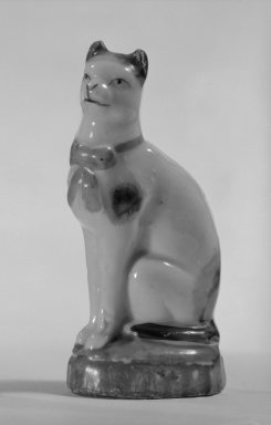  <em>Figure of Cat</em>, ca. 1880. Hard-paste porcelain, 3 3/4 x 1 3/4 x 1 1/4 in. (9.5 x 4.4 x 3.2 cm). Brooklyn Museum, Bequest of Dr. Grace McLean Abbate, 81.53.21. Creative Commons-BY (Photo: Brooklyn Museum, 81.53.21_cropped_bw.jpg)