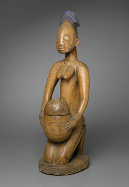 Possibly Maku, master carver of Erin (died 1915). <em>Kneeling Female Figure (Arugba)</em>, early 20th century. Wood, pigment, 22 x 7 x 8 in. (55.9 x 17.8 x 20.3 cm). Brooklyn Museum, Gift of Dr. and Mrs. Robert A. Mandelbaum, 82.103a-b. Creative Commons-BY (Photo: Brooklyn Museum, 82.103a-b_PS2.jpg)