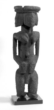 Dogon. <em>Figure with Four Faces (Ginin)</em>, late 19th or early 20th century. Wood, iron, sacrificial materials, 14 1/4 in. (32.6 cm). Brooklyn Museum, Gift of Avery Eliscu, 82.155. Creative Commons-BY (Photo: Brooklyn Museum, 82.155_view1_bw.jpg)