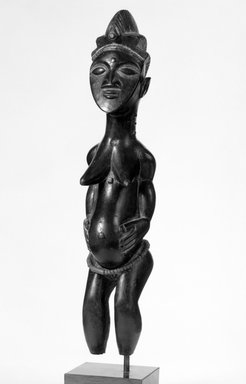 Kulango. <em>Female Figure</em>, early 20th century. Wood, glass beads
, 11 in. (27.9 cm). Brooklyn Museum, Gift of Mr. and Mrs. Brian S. Leyden, 82.214. Creative Commons-BY (Photo: Brooklyn Museum, 82.214_bw.jpg)