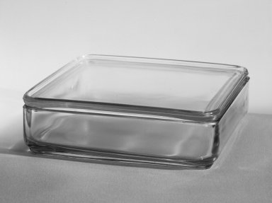 Wilhelm Wagenfeld (1900-1990). <em>Square Container with Lid, from 10-Piece Set of Kitchen Storage Glassware, Kubus</em>, ca. 1938. Clear glass, overall height: 2 1/8 in. (5.5 cm). Brooklyn Museum, Gift of Barry Friedman, 84.121.5a-b. Creative Commons-BY (Photo: Brooklyn Museum, 84.121.5a-b_bw.jpg)