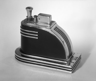 Louis V. Aronson. <em>Cigarette Lighter, "Ronson Touch-Tip,"</em> ca. 1935. Chrome and black-enameled metal, 3 3/8 x 4 3/8 x 2 1/4 in. (8.6 x 11.1 x 5.7 cm). Brooklyn Museum, Gift of David A. Hanks, 84.276a-b. Creative Commons-BY (Photo: Brooklyn Museum, 84.276a-b_bw.jpg)