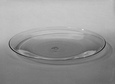 Wilhelm Wagenfeld (1900-1990). <em>Dessert Plate</em>, 1930-1934. Clear heat-resistant glass, 9/16 x 7 7/8 in. (1.4 x 20 cm). Brooklyn Museum, Gift of Barry Friedman, 84.64.10. Creative Commons-BY (Photo: Brooklyn Museum, 84.64.10_bw.jpg)