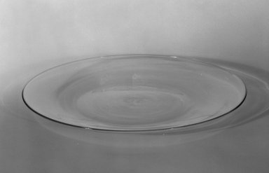 Wilhelm Wagenfeld (1900-1990). <em>Dessert Plate</em>, 1930--1934. Clear heat-resistant glass, 9/16 x 7 7/8 in. (1.4 x 20 cm). Brooklyn Museum, Gift of Barry Friedman, 84.64.11. Creative Commons-BY (Photo: Brooklyn Museum, 84.64.11_bw.jpg)