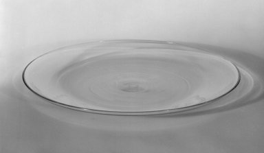 Wilhelm Wagenfeld (1900-1990). <em>Dessert Plate</em>, 1930-1934. Clear heat-resistant glass, 9/16 x 7 7/8 in. (1.4 x 20 cm). Brooklyn Museum, Gift of Barry Friedman, 84.64.12. Creative Commons-BY (Photo: Brooklyn Museum, 84.64.12_bw.jpg)