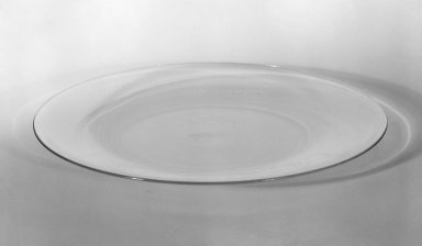 Wilhelm Wagenfeld (1900-1990). <em>Cake Plate</em>, 1930-1934. Clear heat-resistant glass, 9/16 x 85 in. (1.4 x 215.9 cm). Brooklyn Museum, Gift of Barry Friedman, 84.64.15. Creative Commons-BY (Photo: Brooklyn Museum, 84.64.15_bw.jpg)