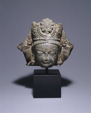  <em>Head of Vishnu Caturanana</em>, ca. 800. Grey schist, 15 x 8 7/8 x 4 in. (38.1 x 22.5 x 10.2 cm). Brooklyn Museum, Purchased with funds given by the Charles Bloom Foundation Inc. in memory of Charles and Mildred Bloom, 85.223.1. Creative Commons-BY (Photo: Brooklyn Museum, 85.223.1_SL1.jpg)