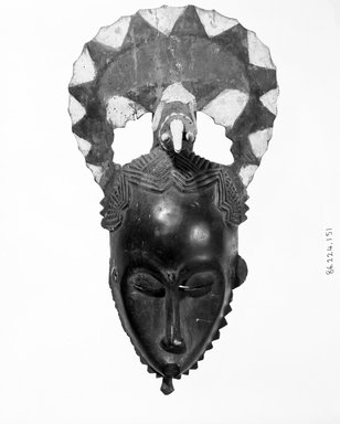 Baule. <em>Mask with Crescent Shaped Form Above Face and Figure of an Elephant</em>, 19th or 20th century. Wood, paint, 2 ferrous nails, 16 1/4 x 9 in. (41.3 x 22.9 cm). Brooklyn Museum, Gift of the Ernest Erickson Foundation, Inc., 86.224.151. Creative Commons-BY (Photo: Brooklyn Museum, 86.224.151_bw.jpg)