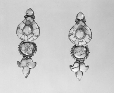  <em>Pair of Woman’s Ear Pendants</em>, 17th or 18th century. Silver inlaid with turquoise, 1 1/2 × 1 × 4 in. (3.8 × 2.5 × 10.2 cm). Brooklyn Museum, Gift of the Ernest Erickson Foundation, Inc., 86.227.43a-b. Creative Commons-BY (Photo: Brooklyn Museum, 86.227.43a-b_acetate_bw.jpg)