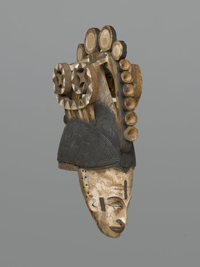 Igbo. <em>Maiden Spirit Helmet Mask (Agbogho Mmwo)</em>, early 20th century. Wood, pigment, string, 19 3/4 x 5 3/4 x 12 in. (50.2 x 14.6 x 30.5 cm). Brooklyn Museum, Gift of Marc and Ruth Franklin in memory of Lillian S. Korzenik, 87.215. Creative Commons-BY (Photo: Brooklyn Museum, 87.215_threequarter_PS1.jpg)