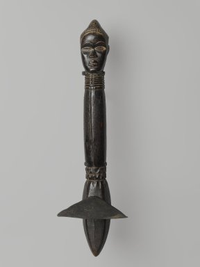 Feia Tomekpa (Dan, flourished 1940s-early 1950s). <em>Ceremonial Hoe</em>, 20th century. Wood, iron, 15 × 2 × 4 1/4 × 8 in. (38.1 × 5.1 × 10.8 × 20.3 cm). Brooklyn Museum, Gift of Mr. and Mrs. Brian S. Leyden, 87.216.2. Creative Commons-BY (Photo: Brooklyn Museum, 87.216.2_front_PS6.jpg)