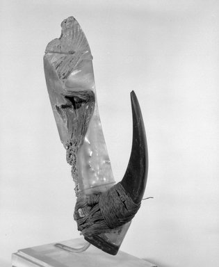  <em>Fishhook</em>. Shell, fiber, 5 3/4 x 1 1/4 x 2 7/8 in. (14.6 x 3.2 x 7.3 cm). Brooklyn Museum, Gift of Marcia and John Friede and Mrs. Melville W. Hall, 87.218.104. Creative Commons-BY (Photo: Brooklyn Museum, 87.218.104_bw.jpg)