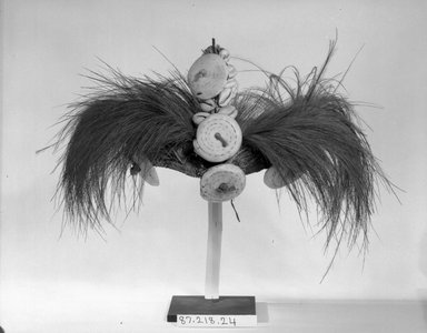  <em>Headdress</em>. Grass, coir, shells, cloth, cassowary feathers, 7 1/2 x 13 in. (19.1 x 33 cm). Brooklyn Museum, Gift of Marcia and John Friede and Mrs. Melville W. Hall, 87.218.24. Creative Commons-BY (Photo: Brooklyn Museum, 87.218.24_bw.jpg)