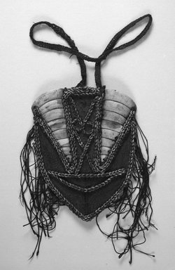  <em>Pectoral Ornament</em>. Boar tusk, woven fiber, nassa shells, fiber cord, 10 1/4 x 8 3/8 in. (26 x 21.2 cm). Brooklyn Museum, Gift of Marcia and John Friede and Mrs. Melville W. Hall, 87.218.56. Creative Commons-BY (Photo: Brooklyn Museum, 87.218.56_bw.jpg)