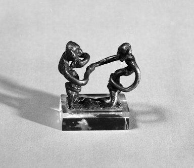 Akan. <em>Gold-weight (abrammuo): two male figures</em>, late 19th-early 20th century. Copper alloy, 1 1/4 x 1 1/2 x 3/4 in. Brooklyn Museum, Gift of Dr. Arthur Dintenfass, 88.187.5. Creative Commons-BY (Photo: Brooklyn Museum, 88.187.5_bw.jpg)