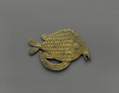 Akan. <em>Gold-weight (abrammuo): fish</em>, 19th–20th century. Cast brass, 2 1/4 x 1 5/8 in. (5.7 x 4.1 cm). Brooklyn Museum, Gift of Mr. and Mrs. Franklin H. Williams, 88.192.70. Creative Commons-BY (Photo: Brooklyn Museum, 88.192.70_PS6.jpg)