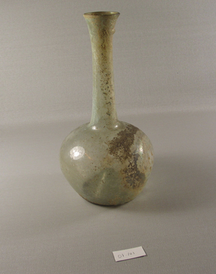 Roman. <em>Bottle of Plain Blown Glass</em>, 1st-5th century C.E. Glass, 9 1/4 x greatest diam. 5 3/8 in. (23.5 x 13.7 cm). Brooklyn Museum, Gift of Robert B. Woodward, 01.101. Creative Commons-BY (Photo: Brooklyn Museum, CUR.01.101_view1.jpg)