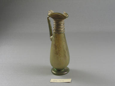 Roman. <em>Jug</em>, 1st-5th century C.E. Glass, 5 1/4 x 1 5/8 x 2 1/8 in. (13.3 x 4.2 x 5.4 cm). Brooklyn Museum, Gift of Robert B. Woodward, 01.122. Creative Commons-BY (Photo: Brooklyn Museum, CUR.01.122_view2.jpg)