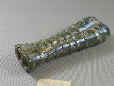 Roman. <em>Double Cosmetic Tube</em>, 4th-5th century C.E. Glass, 5 1/8 x 1 1/16 x 1 7/8 in. (13 x 2.7 x 4.7 cm). Brooklyn Museum, Gift of Robert B. Woodward, 01.123. Creative Commons-BY (Photo: Brooklyn Museum, CUR.01.123_view3.jpg)