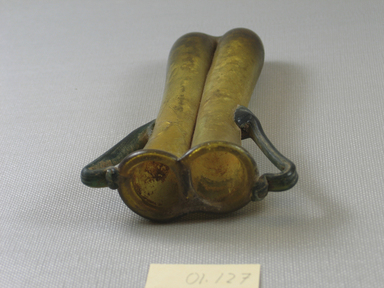Roman. <em>Double Cosmetic Tube with Handles</em>, 4th-5th century C.E. Glass, 4 13/16 x 1 1/16 x 1 7/8 in. (12.2 x 2.7 x 4.7 cm). Brooklyn Museum, Gift of Robert B. Woodward, 01.127. Creative Commons-BY (Photo: Brooklyn Museum, CUR.01.127_top.jpg)