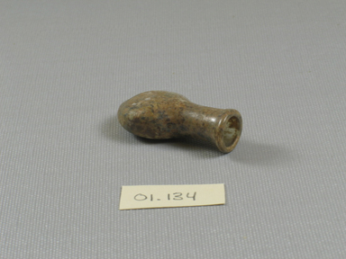 Roman. <em>Small Flat Bottle</em>, 1st-5th century C.E. Glass, 1 7/8 x 9/16 x 1 in. (4.8 x 1.4 x 2.6 cm). Brooklyn Museum, Gift of Robert B. Woodward, 01.134. Creative Commons-BY (Photo: Brooklyn Museum, CUR.01.134_threequarter_front.jpg)