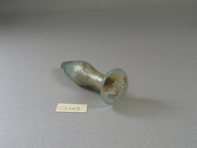 Roman. <em>Small Bottle of Plain Blown Glass</em>, 3rd-4th century C.E. Glass, 3 3/4 x greatest diam. 1 1/2 in. (9.5 x 3.8 cm). Brooklyn Museum, Gift of Robert B. Woodward, 01.143. Creative Commons-BY (Photo: Brooklyn Museum, CUR.01.143_view2.jpg)