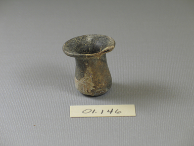Roman. <em>Tiny Bottle of Blown Glass</em>, 1st-5th century C.E. Glass, 1 1/8 x greatest diam. 1 3/16 in. (2.9 x 3 cm). Brooklyn Museum, Gift of Robert B. Woodward, 01.146. Creative Commons-BY (Photo: Brooklyn Museum, CUR.01.146_view1.jpg)