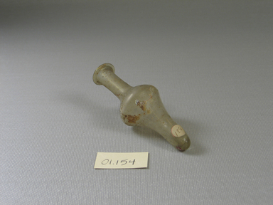 Roman. <em>Bottle of Plain Blown Glass</em>, 4th-7th century C.E. Glass, 3 3/8 x greatest diam. 1 1/4 in. (8.6 x 3.1 cm). Brooklyn Museum, Gift of Robert B. Woodward, 01.154. Creative Commons-BY (Photo: Brooklyn Museum, CUR.01.154_view2.jpg)