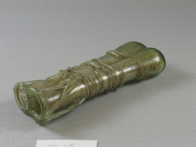 Roman. <em>Double Cosmetic Tube</em>, 4th-5th century C.E. Glass, 4 9/16 x 1 in. (11.6 x 2.6 cm) . Brooklyn Museum, Gift of Robert B. Woodward, 01.15. Creative Commons-BY (Photo: Brooklyn Museum, CUR.01.15_view3.jpg)