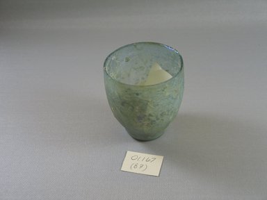Roman. <em>Tumbler of Plain Blown Glass</em>, 1st century B.C.E. - 1st century C.E. Glass, 3 1/8 x greatest diam. 2 3/4 in. (8 x 7 cm)   . Brooklyn Museum, Gift of Robert B. Woodward, 01.167. Creative Commons-BY (Photo: Brooklyn Museum, CUR.01.167.jpg)