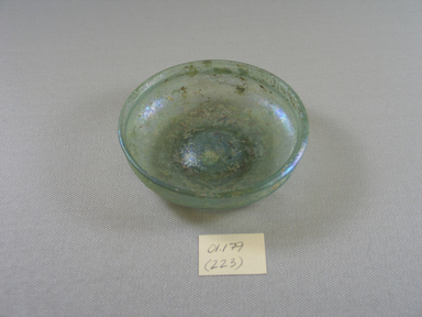 Roman. <em>Small Shallow Dish of Plain Blown Glass</em>, late 4th century C.E. Glass, 7/8 x greatest diam. 4 in. (2.2 x 10.2 cm). Brooklyn Museum, Gift of Robert B. Woodward, 01.179. Creative Commons-BY (Photo: Brooklyn Museum, CUR.01.179.jpg)